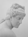 White marble sculpture head of young woman. Statue of sensual renaissance art era naked woman in circlet antique style