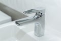 White marble sink with modern overlay basin and shiny stainless steel faucet Royalty Free Stock Photo