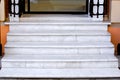 White marble staircase with stone steps at the threshold of the store entrance. Royalty Free Stock Photo