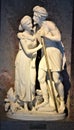 White marble statue, depicting a man with a stick, girding a young woman behind him, at the Kunst Museum in Vienna.