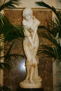 White marble statue of a young girl bathers decorated with beautiful white Banquet hall of the old hotel Astoria.