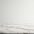 White marble tabletop with gray veining pattern, set against a plain, light-colored Royalty Free Stock Photo