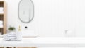 White marble tabletop with towels, shampoo bottle and empty mockup space over blurred bathroom Royalty Free Stock Photo