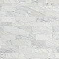 White marble wall featuring neatly arranged rectangular tiles with subtle gray veining. Royalty Free Stock Photo
