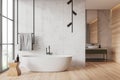 White marble and wooden bathroom interior with tub and sink Royalty Free Stock Photo