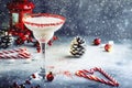 White margarita, Christmas or New Year`s winter alcoholic cocktail with rum, coconut and irish cream with red decor in stylish