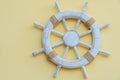 White marine steering wheel on light background. Sea voyages and adventures. Vacation on yacht. Promotional postcards.