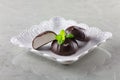 White marshmallow in chocolate and a mint leaf on a grey background Royalty Free Stock Photo