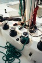 White mast of a sailing yacht with winch halyards and colorful cables Royalty Free Stock Photo