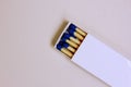 A white matchbox and blue matchsticks on a white background. The box is open. Cooking, hiking, cigarettes. Fire