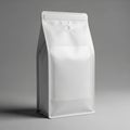 A white, matte-finish coffee bag stands upright against a neutral gray background. Royalty Free Stock Photo