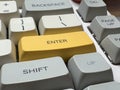 White mechanical keyboard in the office of a programmer employee with big yellow Enter button Royalty Free Stock Photo