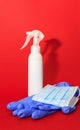 White medcine mask, gloves and bottle of desinfection on a red background Royalty Free Stock Photo