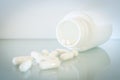 White medical capsules lie on the mirror surface Royalty Free Stock Photo