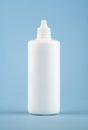 White medical liquid container on light blue background.