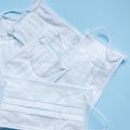 White medical masks on the blue background. Top view Royalty Free Stock Photo