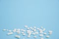 White medical pills on blue background Royalty Free Stock Photo