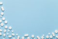 White Medical Pills on Blue Background