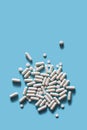 White medical pills on blue background. Royalty Free Stock Photo