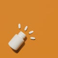 White medical pills spilling out of bottle Royalty Free Stock Photo