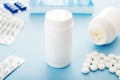 White medical pills and tablets spilling out of a bottle. Mock up bottles with copy space Royalty Free Stock Photo