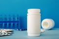 White medical pills and tablets spilling out of a bottle. Mock up bottles with copy space Royalty Free Stock Photo