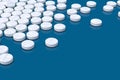 White medicine pills arranged on blue background Royalty Free Stock Photo