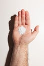 White medicine powder in outstretched palm of male hand