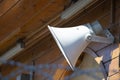 White megaphone hanging on a wood wall Royalty Free Stock Photo