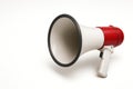 White megaphone with red elements on a clean background. Space for text. Royalty Free Stock Photo