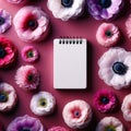 white memo pad surrounded by a sea of colorful anemones. Floral Background Royalty Free Stock Photo