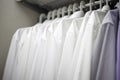 White men`s shirts on hangers in wardrobe Royalty Free Stock Photo