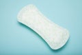 White menstrual pad isolated on blue background