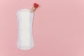 White daily, menstrual woman pad for hygiene or blood period with red pin with a heart as symbol of body love. Concept