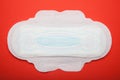 White daily menstrual woman pad on red background