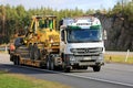 White Mercedes-Benz Actros Hauls Road Maintenance Equipment