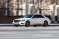 White Mercedes-Benz W222 S-Class driving on the street showing the car in motion