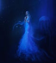 A white mermaid, with very long and blue hair floating under the water. An unusual image, the tail of a jellyfish