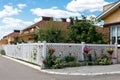 White mesh fence of the front garden in a suburban village Royalty Free Stock Photo