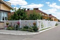 White mesh fence of the front garden in a suburban village