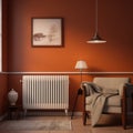 White metal heating radiator mounted on orange wall inside a room. Royalty Free Stock Photo