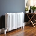 White metal heating radiator mounted on gray wall inside a room. Royalty Free Stock Photo