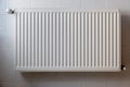 White metal heating radiator mounted on a wall in room interior Royalty Free Stock Photo