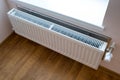 White metal heating radiator mounted on a wall in room interior Royalty Free Stock Photo