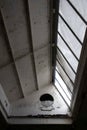 White metal hinged industrial skylight with plastic covering window panes