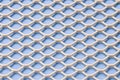 White metal mesh with small cells on a blue background. Close-up. Macro. Industrial background