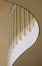 White metal pickets and brass railing on curving balcony Royalty Free Stock Photo