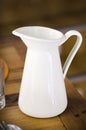 White metal water/milk pitcher in a bar. Royalty Free Stock Photo