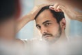 Young Man Applying Lotion For Alopecia And Hair Loss Treatment Royalty Free Stock Photo