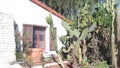 White mexican old house, window and garden, succulent cactus plant, California. Royalty Free Stock Photo